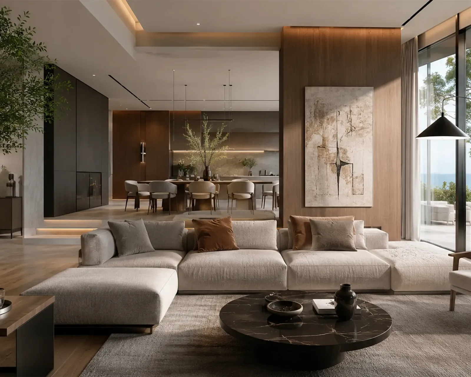 Open-plan living and dining interior with a sea-facing glass wall in a Nidhi Land Developers home